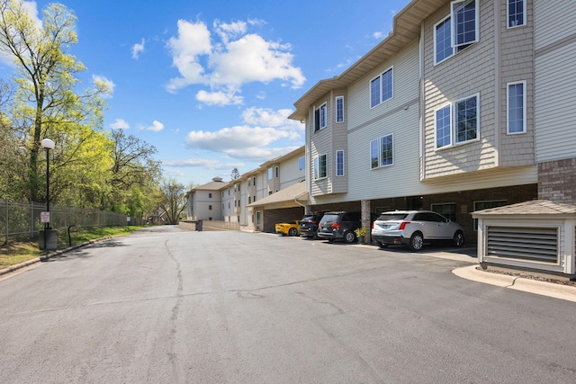 11030 Mississippi Blvd NW Unit 221, Coon Rapids, MN 55433 - view of asphalt street with street lighting, a residential view, and curbs