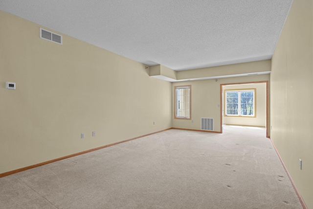 11030 Mississippi Blvd NW Unit 221, Coon Rapids, MN 55433 - carpeted spare room featuring a textured ceiling and baseboards