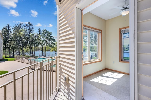 11030 Mississippi Blvd NW Unit 221, Coon Rapids, MN 55433 - balcony with view of pool, a ceiling fan, a patio, and a water view