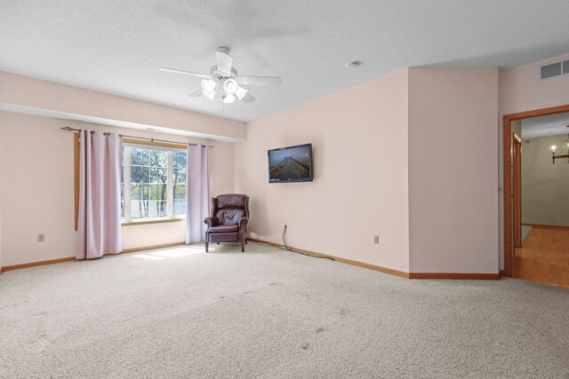 11030 Mississippi Blvd NW Unit 221, Coon Rapids, MN 55433 - unfurnished room featuring carpet floors, a ceiling fan, a textured ceiling, baseboards, and a chandelier