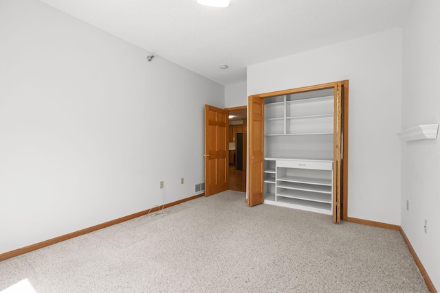 11030 Mississippi Blvd NW Unit 221, Coon Rapids, MN 55433 - unfurnished bedroom featuring light carpet, a closet, and baseboards