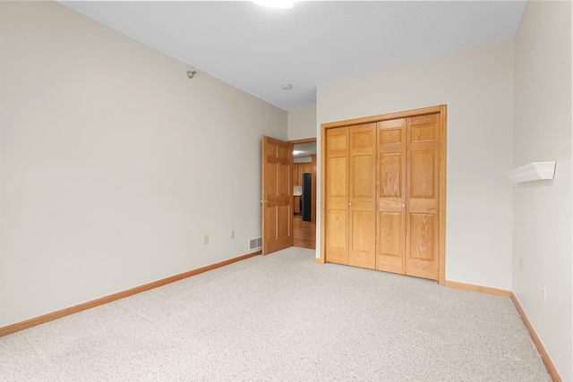 11030 Mississippi Blvd NW Unit 221, Coon Rapids, MN 55433 - unfurnished bedroom with light colored carpet, baseboards, and a closet