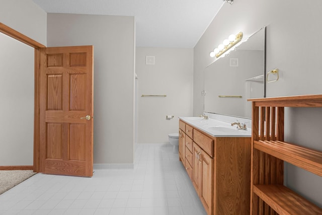 11030 Mississippi Blvd NW Unit 221, Coon Rapids, MN 55433 - bathroom featuring double vanity, toilet, and baseboards