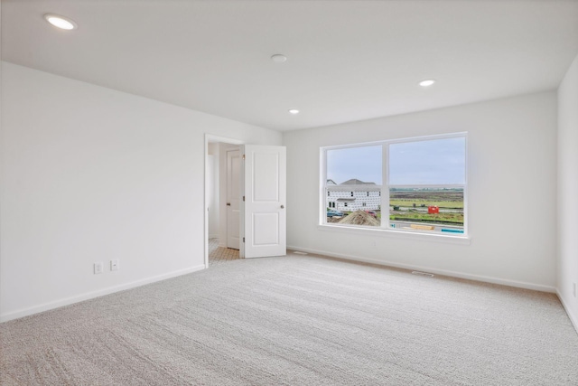 empty room with light colored carpet