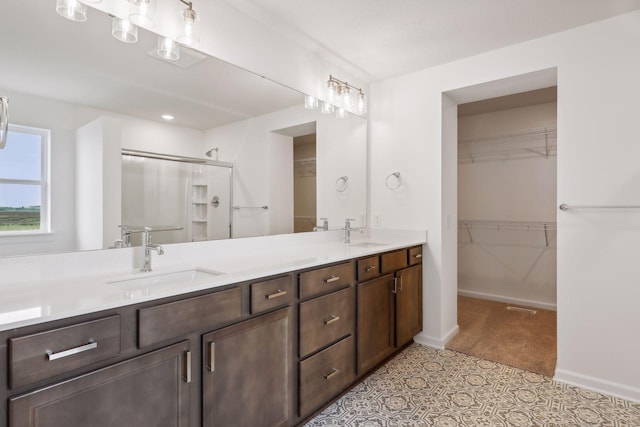 bathroom featuring vanity and a shower with door