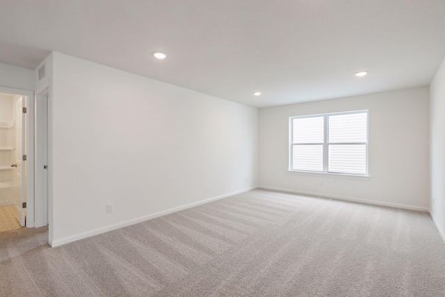 empty room featuring light colored carpet