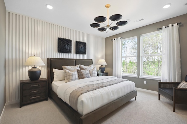 bedroom with light carpet and a chandelier