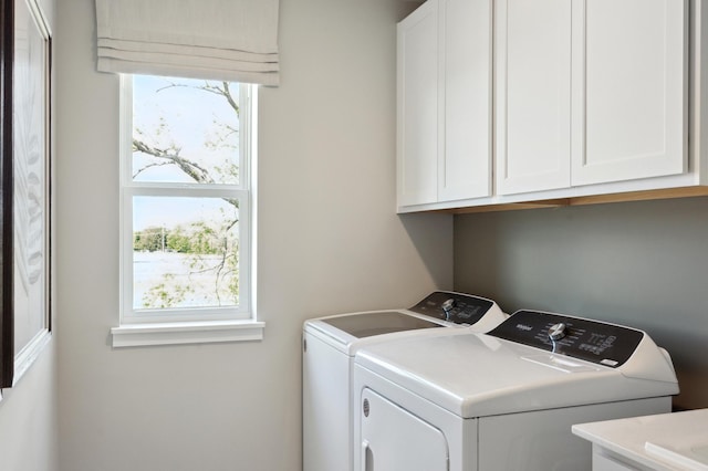 washroom featuring cabinets, a wealth of natural light, and independent washer and dryer