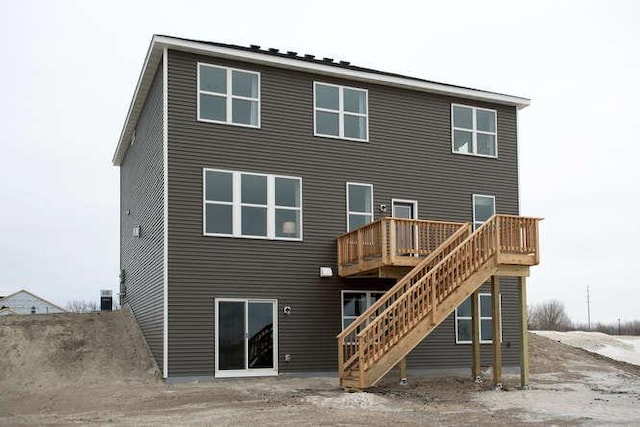 rear view of property featuring a deck