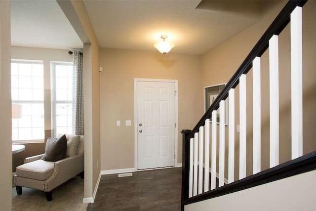 entryway with dark hardwood / wood-style flooring