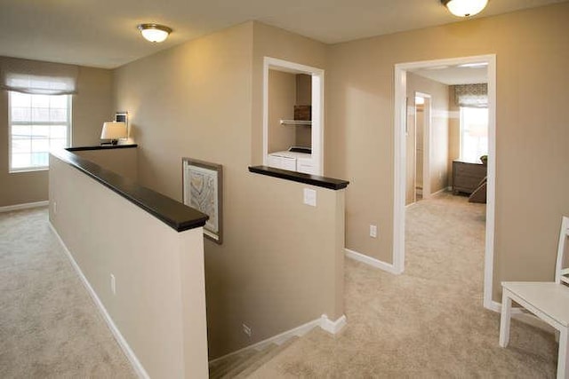 hallway with light colored carpet