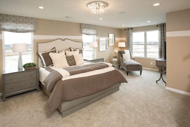 bedroom featuring light carpet and an inviting chandelier