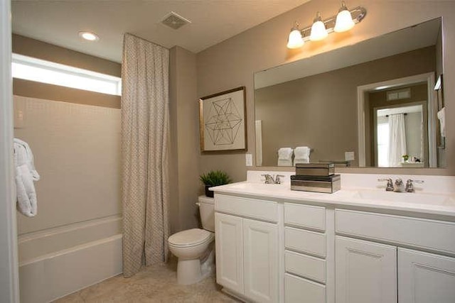 full bathroom featuring shower / bathtub combination with curtain, vanity, and toilet