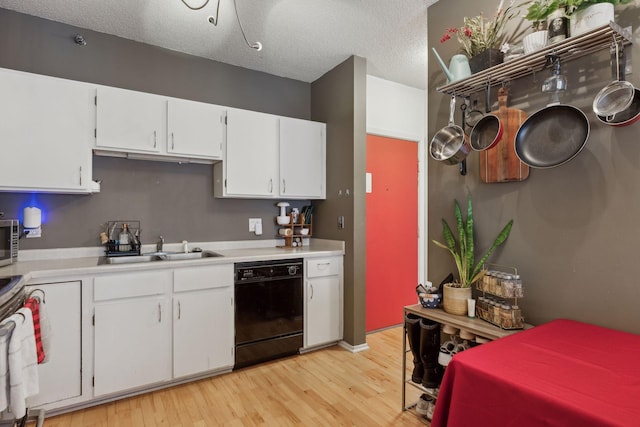 kitchen with sink, white cabinetry, stove, black dishwasher, and light wood-type flooring