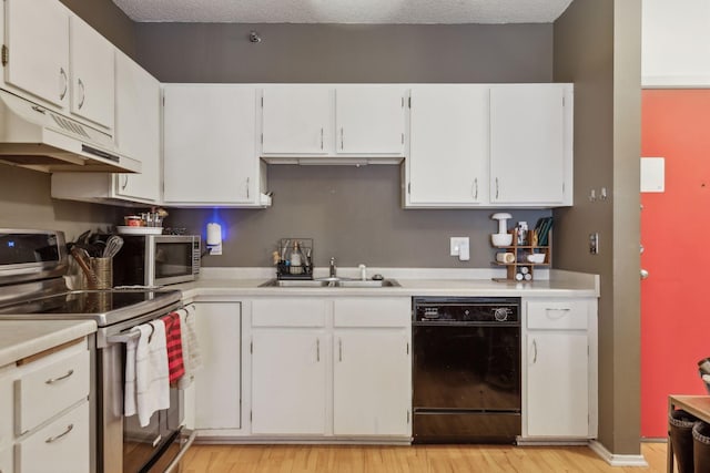 kitchen with light wood-type flooring, stainless steel appliances, sink, and white cabinets