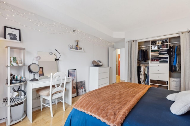 bedroom featuring hardwood / wood-style floors and a closet