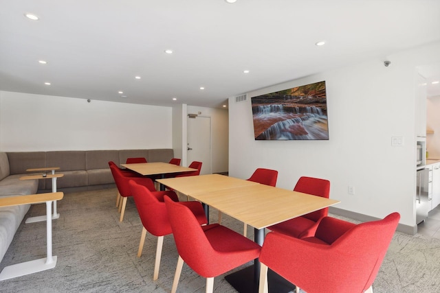 dining area with light colored carpet