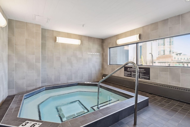 view of swimming pool with an indoor in ground hot tub