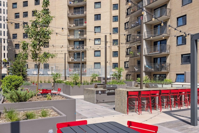 view of home's community featuring exterior bar, area for grilling, and a patio area