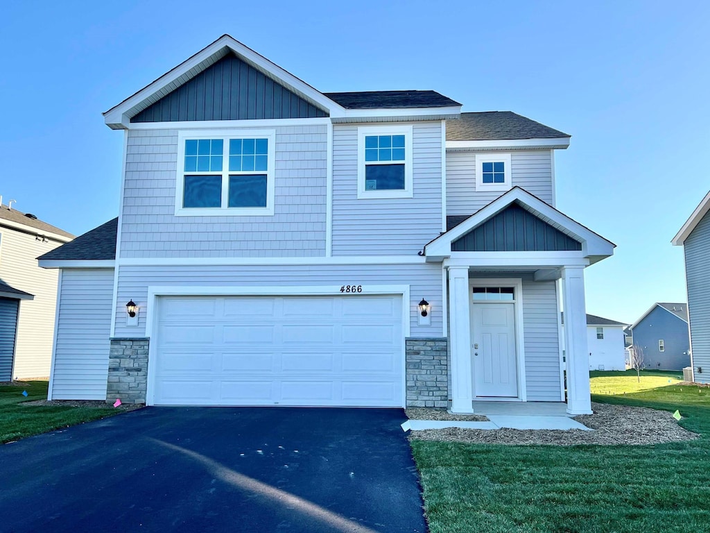 view of front of house with a garage and a front lawn