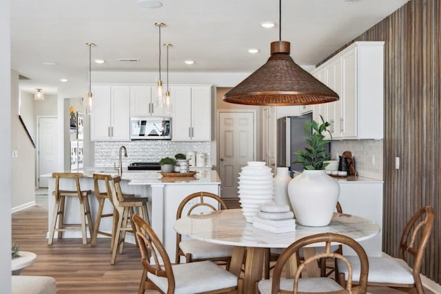 dining room featuring sink and hardwood / wood-style floors