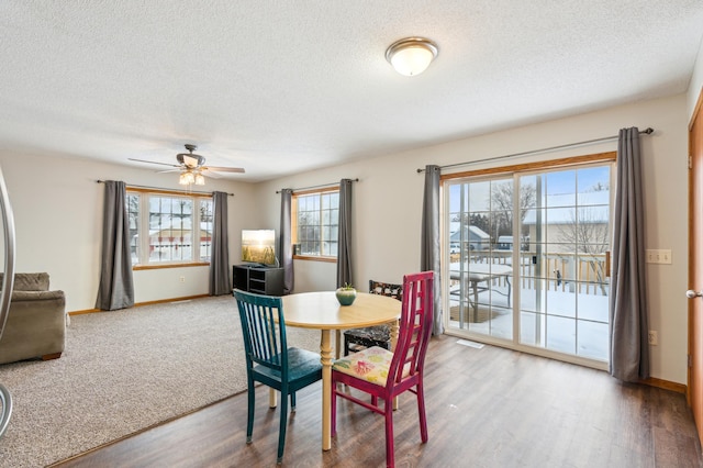 dining space featuring ceiling fan, hardwood / wood-style flooring, and a textured ceiling