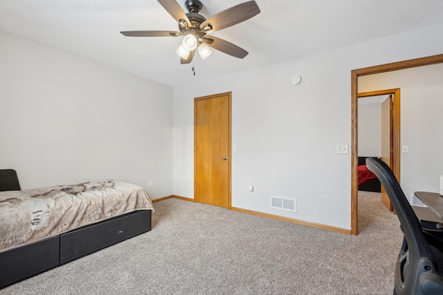 carpeted bedroom with a textured ceiling and ceiling fan