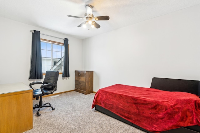 carpeted bedroom featuring a textured ceiling and ceiling fan