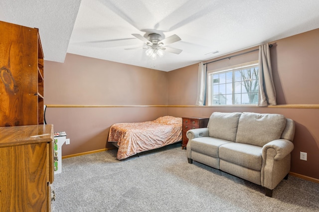 bedroom featuring ceiling fan, carpet, and a textured ceiling