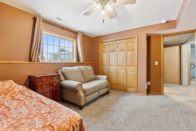 bedroom featuring ceiling fan, a closet, and light carpet