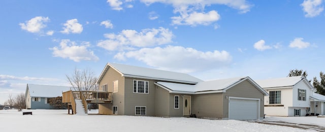 view of front of home with a wooden deck and a garage