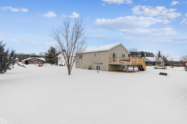 snow covered house with a deck