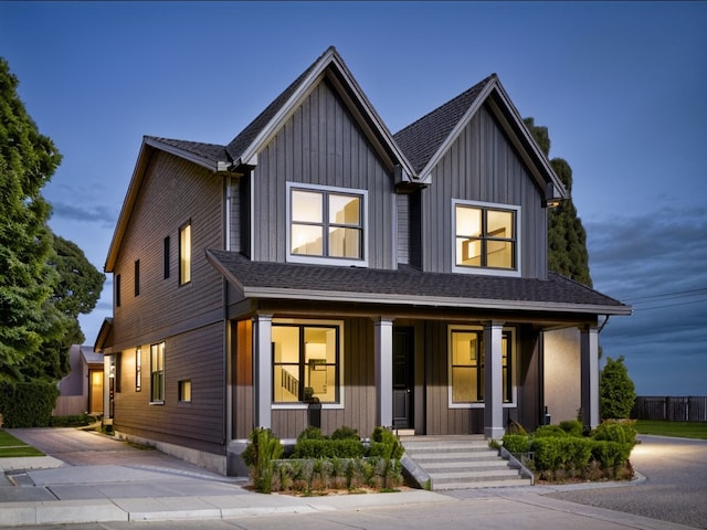 modern farmhouse style home featuring a porch, roof with shingles, and board and batten siding