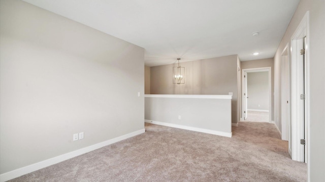 7472 170th Ave NW, Ramsey, MN 55303 - carpeted spare room with baseboards and a chandelier
