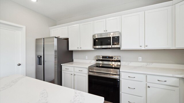7472 170th Ave NW, Ramsey, MN 55303 - kitchen with white cabinetry and stainless steel appliances