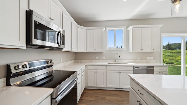 7472 170th Ave NW, Ramsey, MN 55303 - kitchen with white cabinetry, a sink, stainless steel appliances, and a wealth of natural light