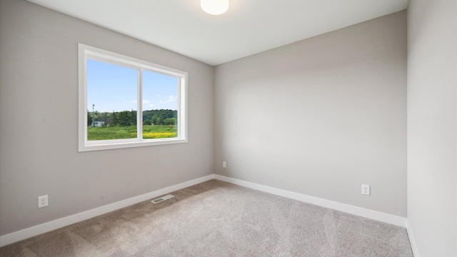7472 170th Ave NW, Ramsey, MN 55303 - spare room featuring baseboards, carpet floors, and visible vents