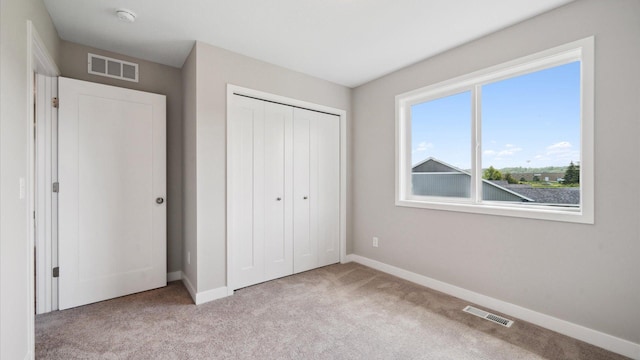 7472 170th Ave NW, Ramsey, MN 55303 - unfurnished bedroom with baseboards, visible vents, and carpet flooring
