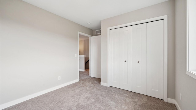 7472 170th Ave NW, Ramsey, MN 55303 - unfurnished bedroom featuring baseboards, visible vents, a closet, and carpet