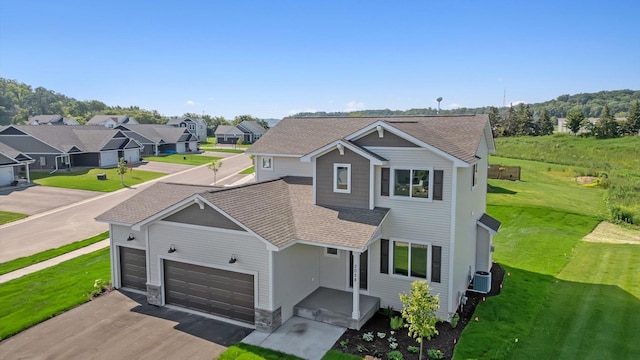 7472 170th Ave NW, Ramsey, MN 55303 - view of front facade featuring a residential view, aphalt driveway, a front yard, a garage, and a shingled roof