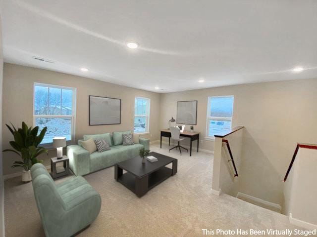 carpeted living area with visible vents, baseboards, and recessed lighting