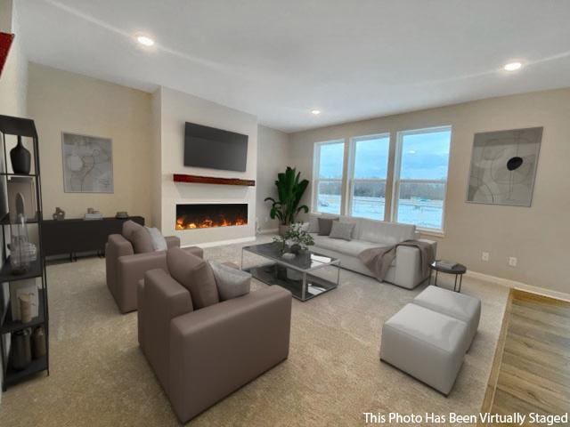 living area with a warm lit fireplace, baseboards, and recessed lighting