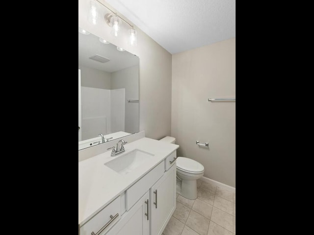 bathroom featuring vanity, tile patterned floors, toilet, and walk in shower