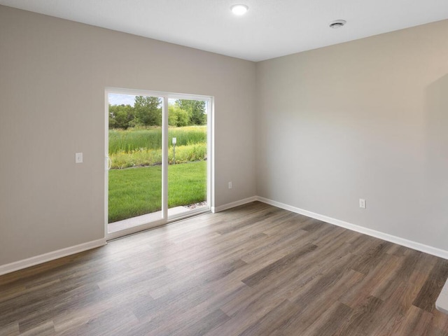 empty room with dark hardwood / wood-style flooring