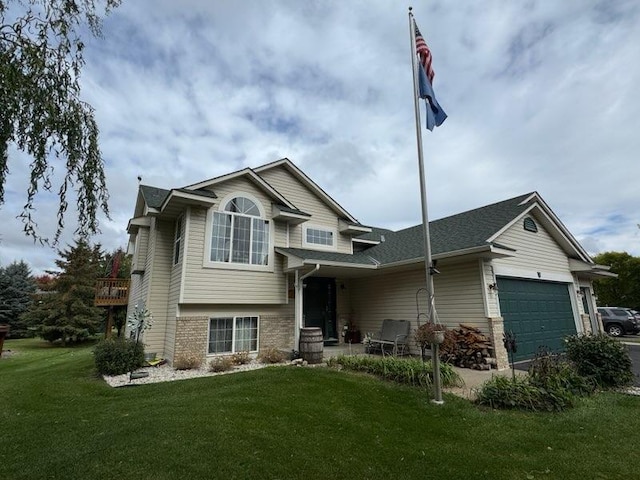 view of front of property with a garage and a front lawn