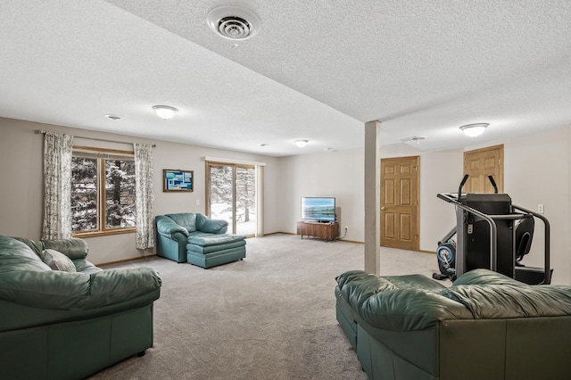 carpeted living room featuring a textured ceiling