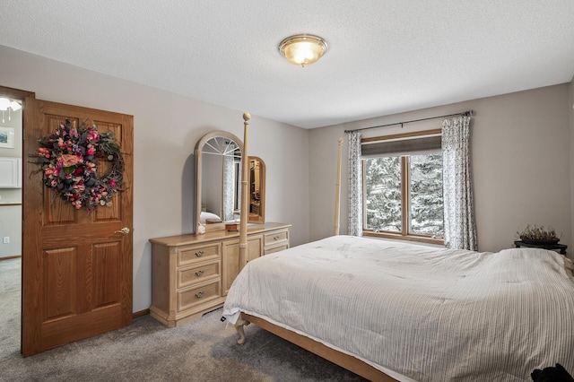 bedroom featuring light carpet and a textured ceiling