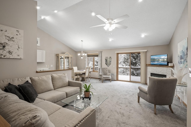 living room featuring ceiling fan with notable chandelier, high vaulted ceiling, and light carpet