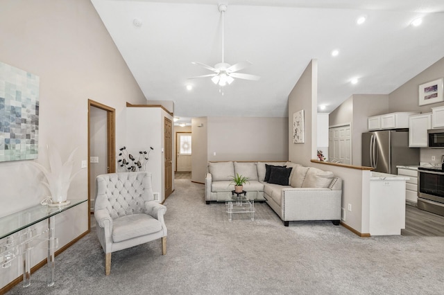 living room featuring ceiling fan, light colored carpet, and high vaulted ceiling