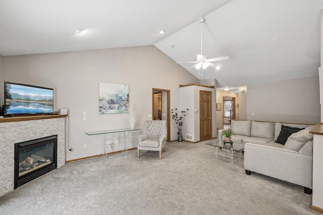 carpeted living room featuring a stone fireplace, high vaulted ceiling, and ceiling fan